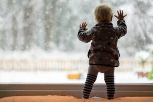 kid in front of window